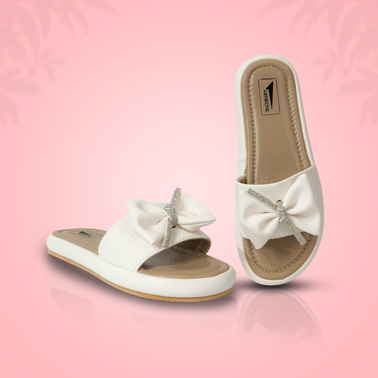 White sandals with bow details on a pink background