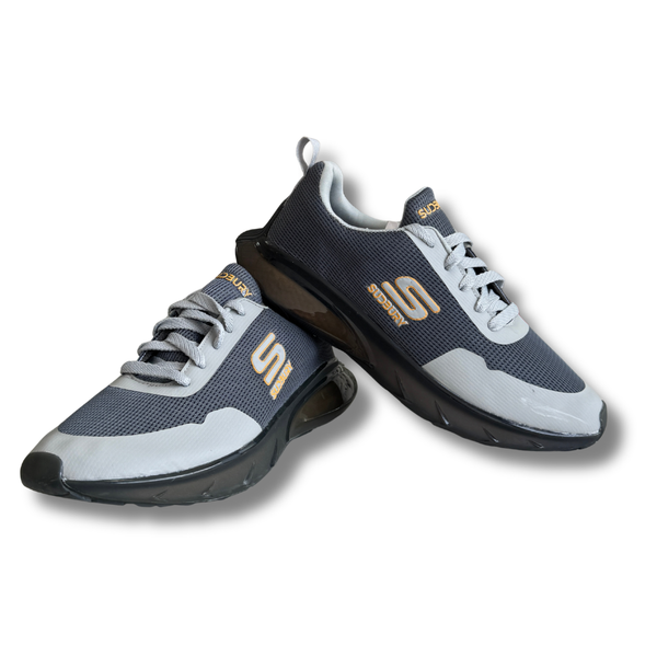 Gray and black athletic shoes with gold logo on a white background