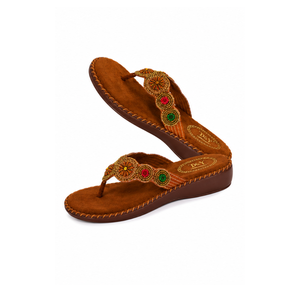 Brown sandal with decorative straps and colorful stones on a white background